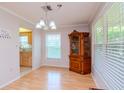 Light and airy dining room with hardwood floors and a view into the kitchen at 4961 Grist Mill Cir, New Port Richey, FL 34655