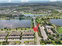 Aerial view showcasing community amenities and lake at 6357 Shore Vista Pl, Apollo Beach, FL 33572