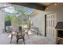 Relaxing patio with seating area, screened enclosure, and brick pavers at 6357 Shore Vista Pl, Apollo Beach, FL 33572