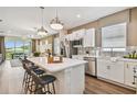 Modern kitchen with white cabinets, an island, and stainless appliances at 9210 Ballaster Pointe Loop, Parrish, FL 34219