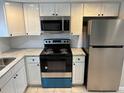 Updated kitchen featuring stainless steel appliances and granite countertops at 811 Russell Ln # 309, Brandon, FL 33510