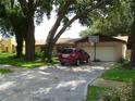 Brick ranch home with a two-car garage and a basketball hoop at 803 Bills Cir, Brandon, FL 33511