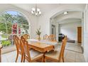 Bright dining room with large window and chandelier at 1130 Big Creek Dr, Wesley Chapel, FL 33544