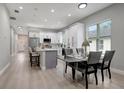 Open concept dining area with modern table and chairs at 3410 E Henry Ave, Tampa, FL 33610