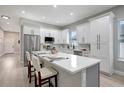 Modern kitchen with white cabinets, quartz countertops, and an island at 3410 E Henry Ave, Tampa, FL 33610