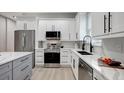 Modern kitchen with white shaker cabinets and quartz countertops at 3410 E Henry Ave, Tampa, FL 33610