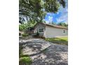 House exterior with driveway and partial pool view at 5051 6Th St, Zephyrhills, FL 33542