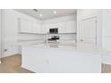 Modern kitchen with white cabinets and quartz countertops at 3008 Forest Meadow Ave, Valrico, FL 33594