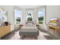 Bright bedroom with a bed, desk, and ample natural light at 3008 Forest Meadow Ave, Valrico, FL 33594