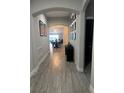 Bright entryway with gray wood-look tile floors, and a modern console table at 11811 Jackson Landing Pl, Tampa, FL 33624