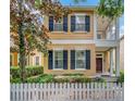 Inviting two-story home featuring dark shutters and a quaint front porch at 11329 Emerson Lake Dr, Riverview, FL 33578