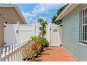 Backyard with brick patio and white fence at 8816 Ascot Ct, Tampa, FL 33634