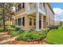 Two story house with light beige siding, dark shutters, and a manicured lawn at 11329 Emerson Lake Dr, Riverview, FL 33578
