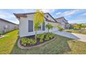 Front view of a one-story house, showcasing landscaping and a curb appeal at 9316 Channing Hill Dr, Ruskin, FL 33573