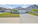 One-story house with a two-car garage and a well-maintained lawn at 9316 Channing Hill Dr, Ruskin, FL 33573