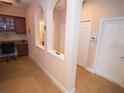 This office features an attached desk and a lovely view of the hall through beautiful arches, offering ample space for productivity at 809 Chipper Dr, Sun City Center, FL 33573