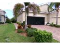 House exterior featuring a two-car garage with a retractable screen at 809 Chipper Dr, Sun City Center, FL 33573