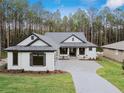 Two story home with gray and white exterior, two car garage, and paver driveway at 19411 Sheltered Hill Dr, Brooksville, FL 34601