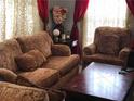 Living room with brown couch and armchair at 2905 W Cherry St, Tampa, FL 33607