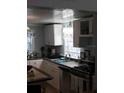 Kitchen with white cabinets and gas range at 2905 W Cherry St, Tampa, FL 33607