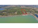 Expansive aerial view of a parcel outlined in red near a reservoir and tree-lined boundary at 30737 Elam Rd, Wesley Chapel, FL 33545