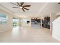 Open concept living room and kitchen with tile floors at 16632 Goose Ribbon Pl, Wimauma, FL 33598