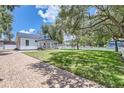 Charming white cottage with a metal roof and porch at 5602 N Ola Ave, Tampa, FL 33604
