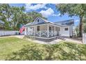 Charming white cottage with a metal roof and porch at 5602 N Ola Ave, Tampa, FL 33604