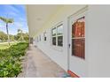 Clean and bright apartment building exterior with a walkway and landscaping at 5728 14Th N Ave # 104B, St Petersburg, FL 33710