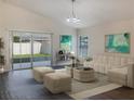 Spacious living room with sectional sofa and large windows at 16707 Magnolia Reserve Pl, Wimauma, FL 33598