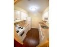 Modern eat-in kitchen with white cabinets and dark wood floors at 4335 Aegean Dr # 106A, Tampa, FL 33611