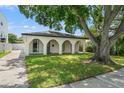 Charming ranch house with arched entryway and mature tree at 626 E Davis Blvd, Tampa, FL 33606