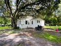 Cozy cottage-style home nestled under large shade trees at 5907 8Th S Ave, Tampa, FL 33619