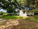 Small house with a large yard and mature trees at 5907 8Th S Ave, Tampa, FL 33619