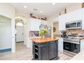 Kitchen with island, stainless steel appliances and light wood floors at 11038 Ancient Futures Dr, Tampa, FL 33647