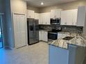 Modern kitchen with stainless steel appliances and granite countertops at 3611 Bellmeade Ct, Wesley Chapel, FL 33543