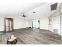 Bright living room with wood-look floors and sliding glass doors at 684 Corrientes Cir, Punta Gorda, FL 33983