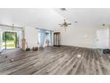 Spacious living room featuring wood-look floors and vaulted ceilings at 684 Corrientes Cir, Punta Gorda, FL 33983