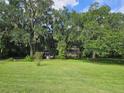 House nestled in a wooded area with spacious yard at 15222 Lost Lake Ln, Lithia, FL 33547