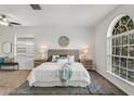 Spacious main bedroom with large window, plush bed, and neutral decor at 1735 Lady Palm Ct, Trinity, FL 34655