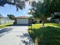 Single-story home with a large front yard, driveway, and attached garage at 3422 29Th E St, Bradenton, FL 34208
