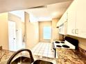 Cozy kitchen with granite countertops and white cabinetry at 8628 Hunters Key Cir, Tampa, FL 33647