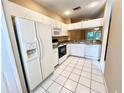 Efficient kitchen offering white cabinets, granite countertops, and appliances at 8628 Hunters Key Cir, Tampa, FL 33647