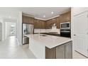 New kitchen featuring stainless steel appliances, quartz counters, and ample cabinet space at 20783 Balsam Hill Rd, Land O Lakes, FL 34638