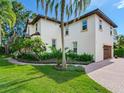 Two-story home with attached garage and lush landscaping at 2501 N Dundee St, Tampa, FL 33629