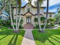 Two-story home with palm trees, brick walkway, and double front doors at 2501 N Dundee St, Tampa, FL 33629