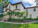 Two-story home with palm trees, brick walkway, and double front doors at 2501 N Dundee St, Tampa, FL 33629