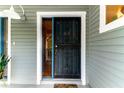 Front door entrance with security screen and side window at 2511 Dolly Bay Dr # 301, Palm Harbor, FL 34684
