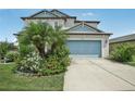 Two story house with landscaped yard and driveway at 30425 Pecan Valley Loop, Wesley Chapel, FL 33543