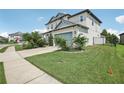 Two-story house with a landscaped yard and a two-car garage at 30425 Pecan Valley Loop, Wesley Chapel, FL 33543